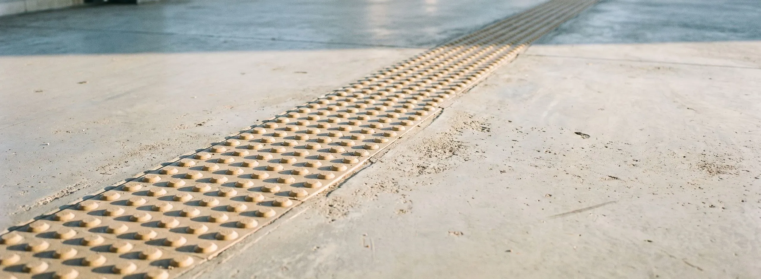 Taktiles Bodenleitsystem aus Noppenplatten in einem Betonboden